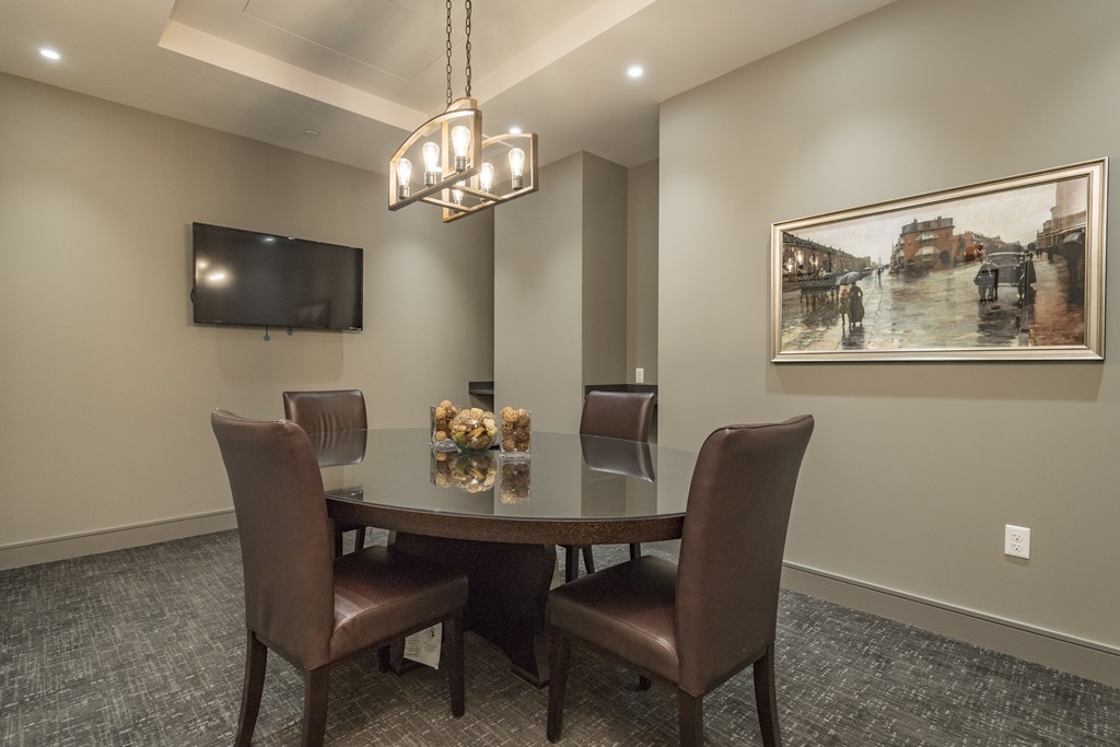 121 Portland Street, Unit 703 Boston, MA 02114 - Photo 13 of 13 a view of a dining room with furniture and chandelier