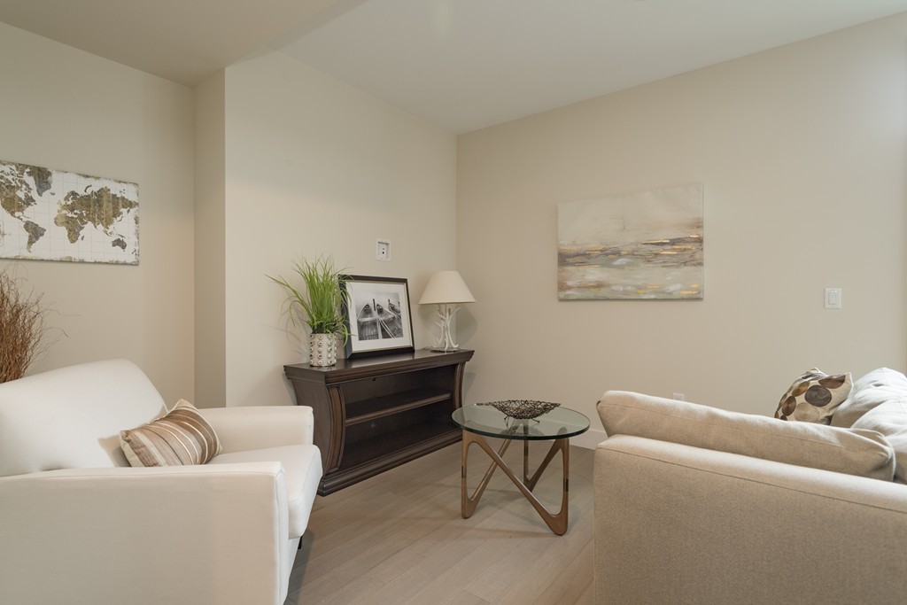 121 Portland Street, Unit 703 Boston, MA 02114 - Photo 3 of 13 a living room with furniture and a couch