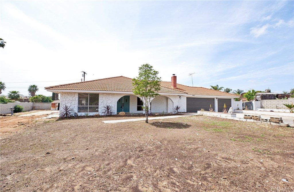 16061 Suttles Drive Riverside, CA 92504 - Photo 1 of 36 a front view of a house with a yard and garage