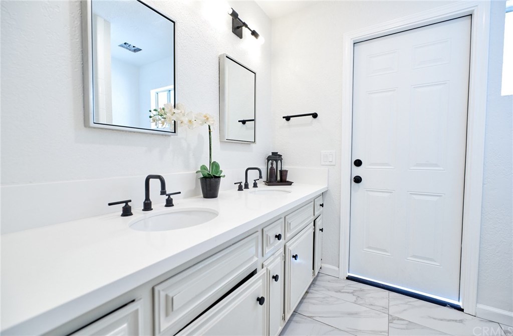 16061 Suttles Drive Riverside, CA 92504 - Photo 17 of 36 a bathroom with a sink and a mirror