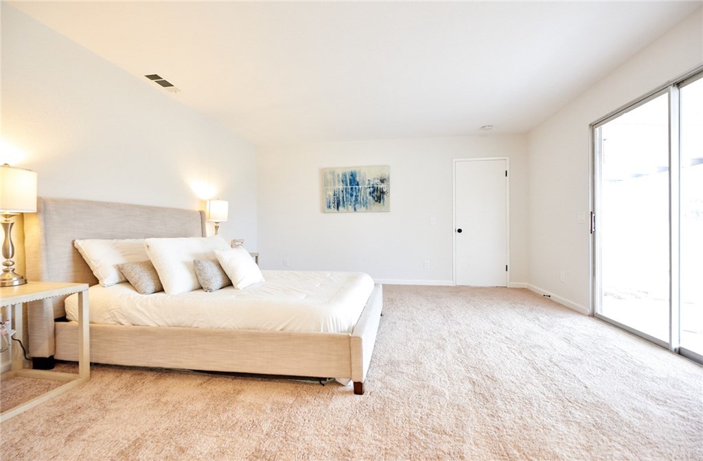 16061 Suttles Drive Riverside, CA 92504 - Photo 23 of 36 a spacious bedroom with a bed and a window