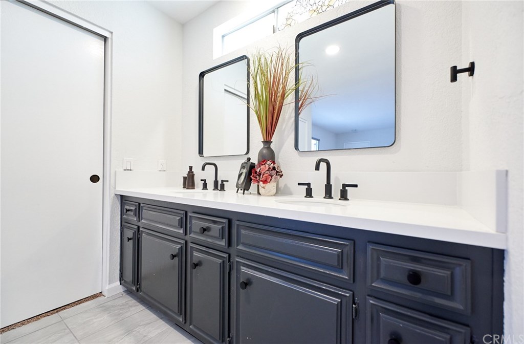 16061 Suttles Drive Riverside, CA 92504 - Photo 26 of 36 a bathroom with a sink and a mirror