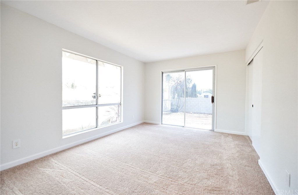 16061 Suttles Drive Riverside, CA 92504 - Photo 10 of 36 an empty room with windows and city view