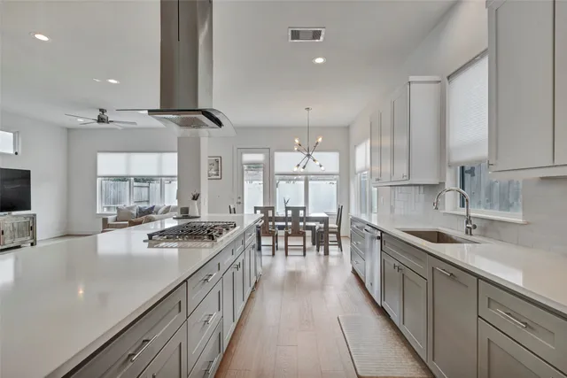 a kitchen with lots of counter top space a sink appliances and cabinets