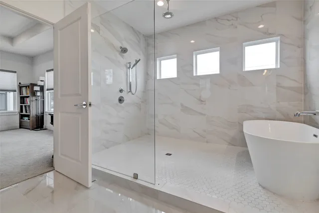 a bathroom with a bathtub and shower