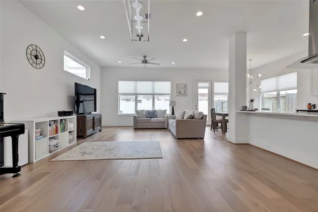 a large living room with stainless steel appliances lots of counter space and a window