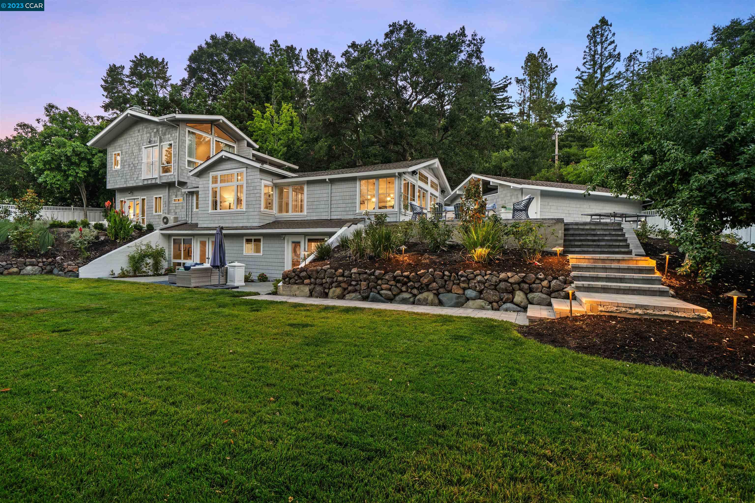 a front view of a house with a garden