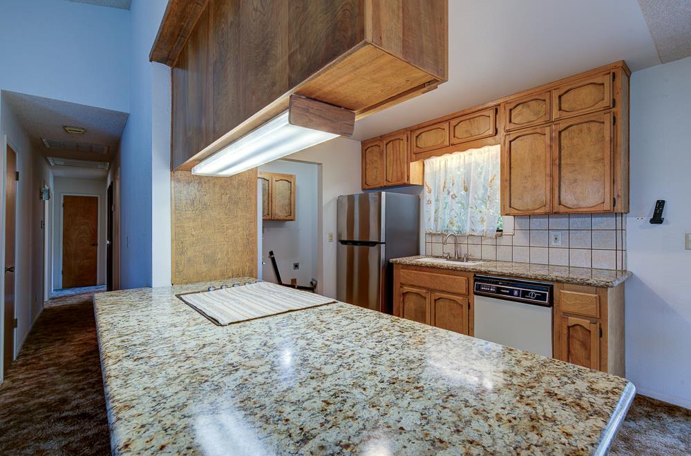 27266 Twin Ponds Road Clovis, CA 93619 - Photo 21 of 45 a kitchen with stainless steel appliances granite countertop a refrigerator and a stove top oven