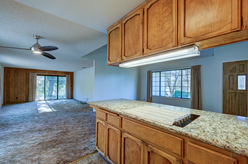 27266 Twin Ponds Road Clovis, CA 93619 - Photo 23 of 45 a kitchen with granite countertop cabinets and window