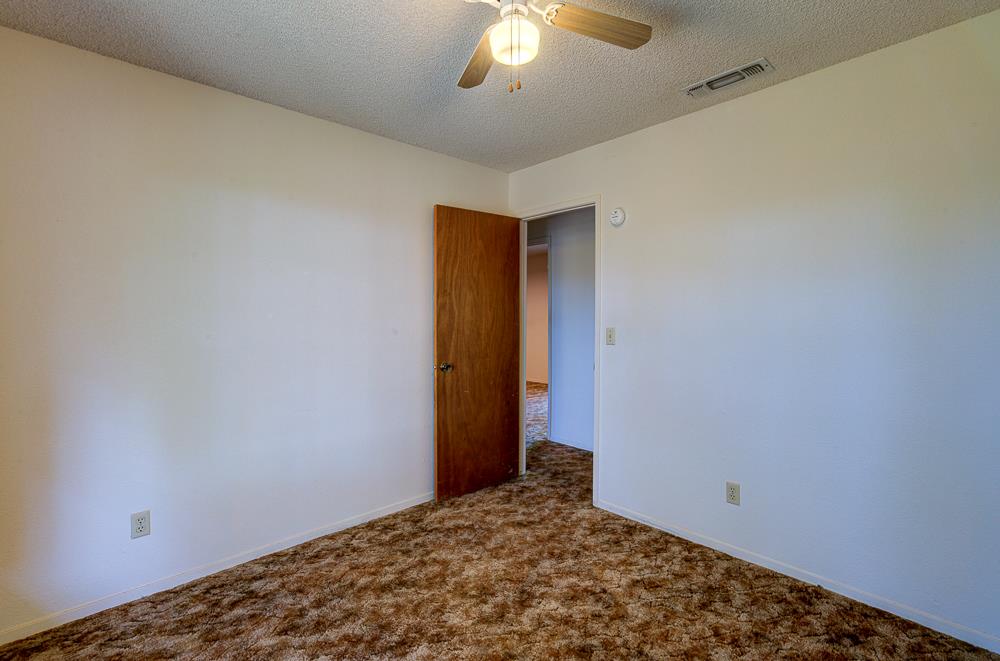 27266 Twin Ponds Road Clovis, CA 93619 - Photo 27 of 45 a view of a room with a chandelier fan and a window