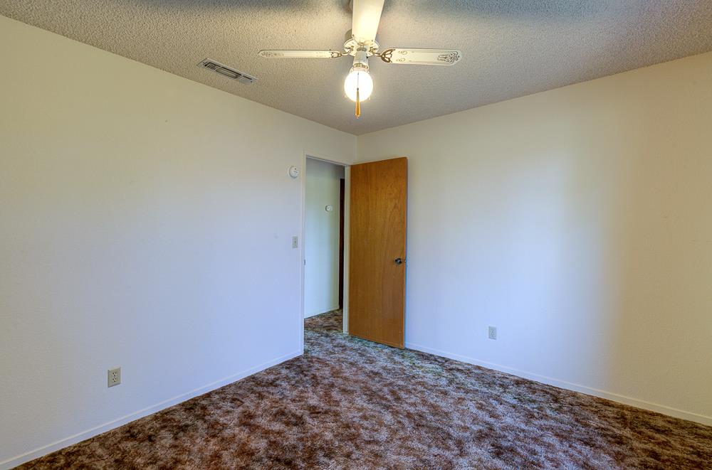 27266 Twin Ponds Road Clovis, CA 93619 - Photo 29 of 45 a view of a hallway with a chandelier fan and a chandelier fan
