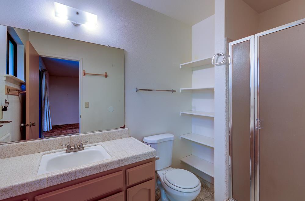 27266 Twin Ponds Road Clovis, CA 93619 - Photo 33 of 45 a bathroom with a sink toilet vanity and shower