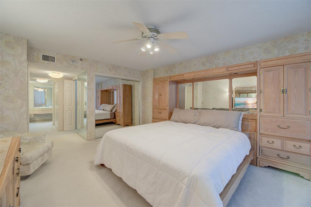 4600 South Ocean Boulevard, Unit 603 Highland Beach, FL 33487 - Photo 13 of 35 a spacious bedroom with a large bed and a chandelier