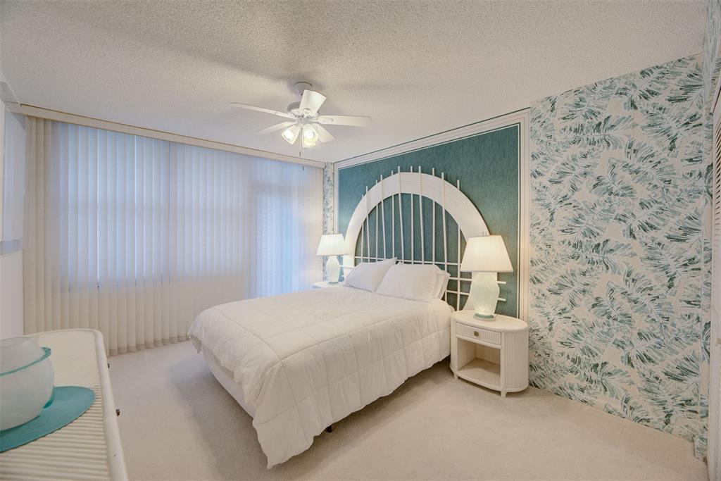 4600 South Ocean Boulevard, Unit 603 Highland Beach, FL 33487 - Photo 16 of 35 a bedroom with a bed and a ceiling fan