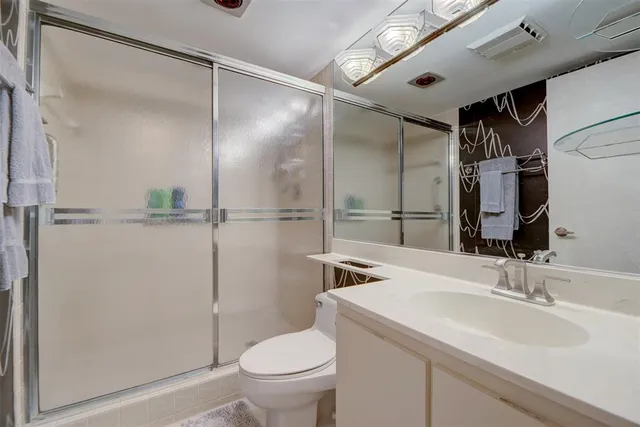a bathroom with a toilet and a mirror