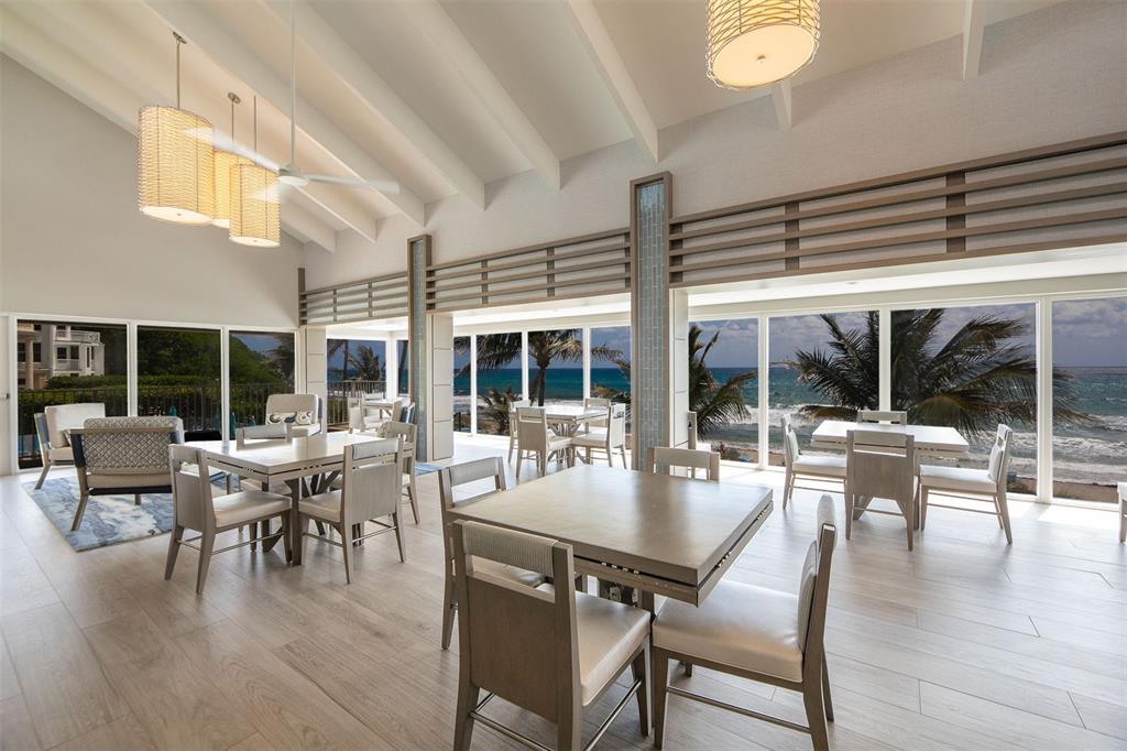 4600 South Ocean Boulevard, Unit 603 Highland Beach, FL 33487 - Photo 23 of 35 a dining room with wooden floor and large windows