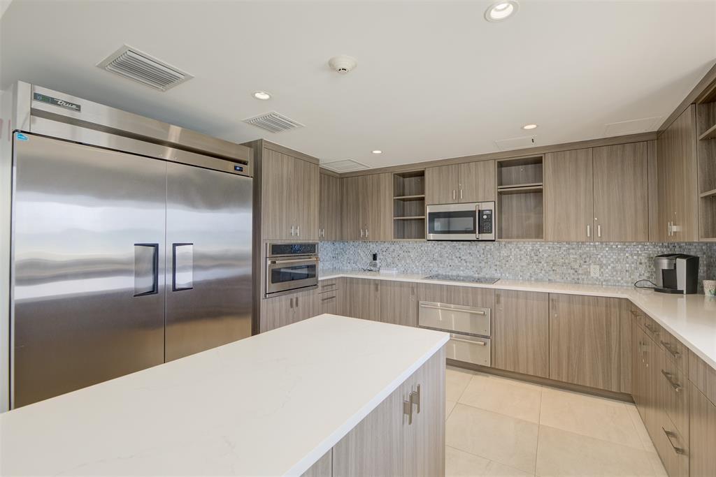 4600 South Ocean Boulevard, Unit 603 Highland Beach, FL 33487 - Photo 29 of 35 a kitchen with stainless steel appliances a sink and refrigerator