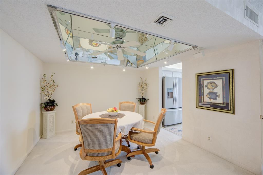 4600 South Ocean Boulevard, Unit 603 Highland Beach, FL 33487 - Photo 7 of 35 a view of a dining room with furniture and a chandelier fan