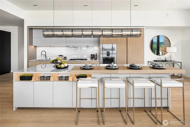 a kitchen with stainless steel appliances kitchen island granite countertop a sink and cabinets