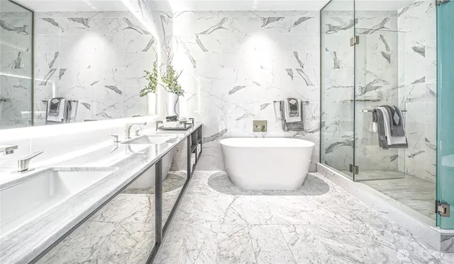 a large white tub sitting next to a bathroom sink