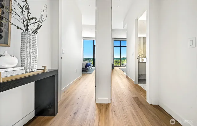 a view of a hallway with wooden floor and staircase