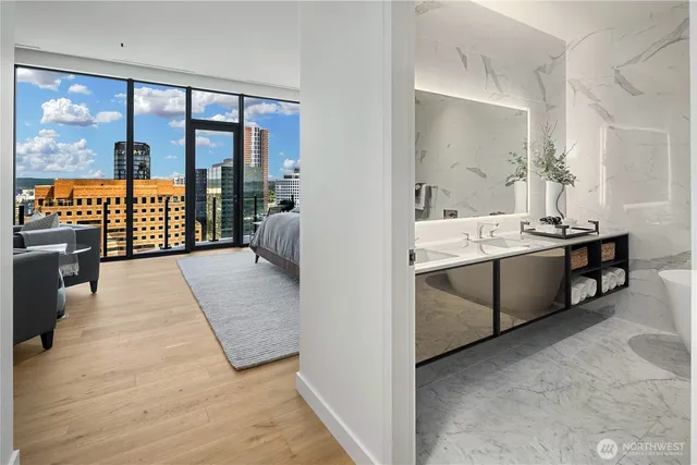 a en suite bathroom with double vanity and a tub