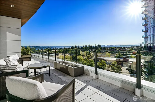 a terrace with outdoor seating and city view