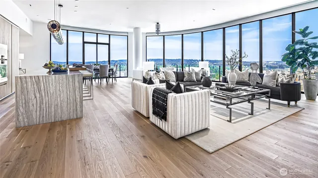 a living room with furniture and floor to ceiling windows