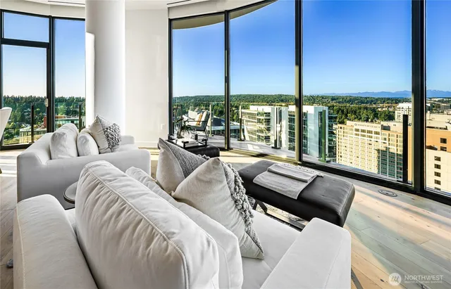 a living room with furniture and large windows
