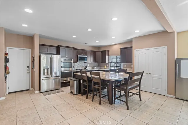 a large kitchen with a table and chairs