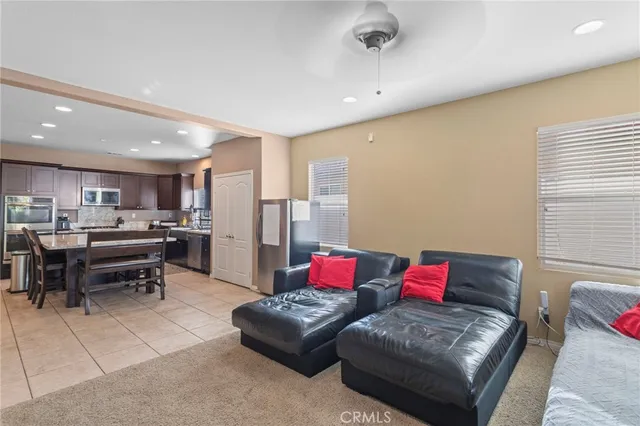 a living room with furniture and kitchen view