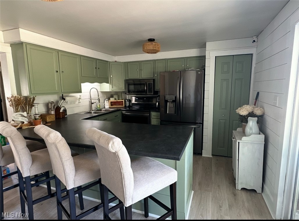 2405 Irish Ridge Road Philo, OH 43771 - Photo 3 of 18 Kitchen with green cabinets, refrigerator with ice dispenser, electric range, a sink, and dark countertops