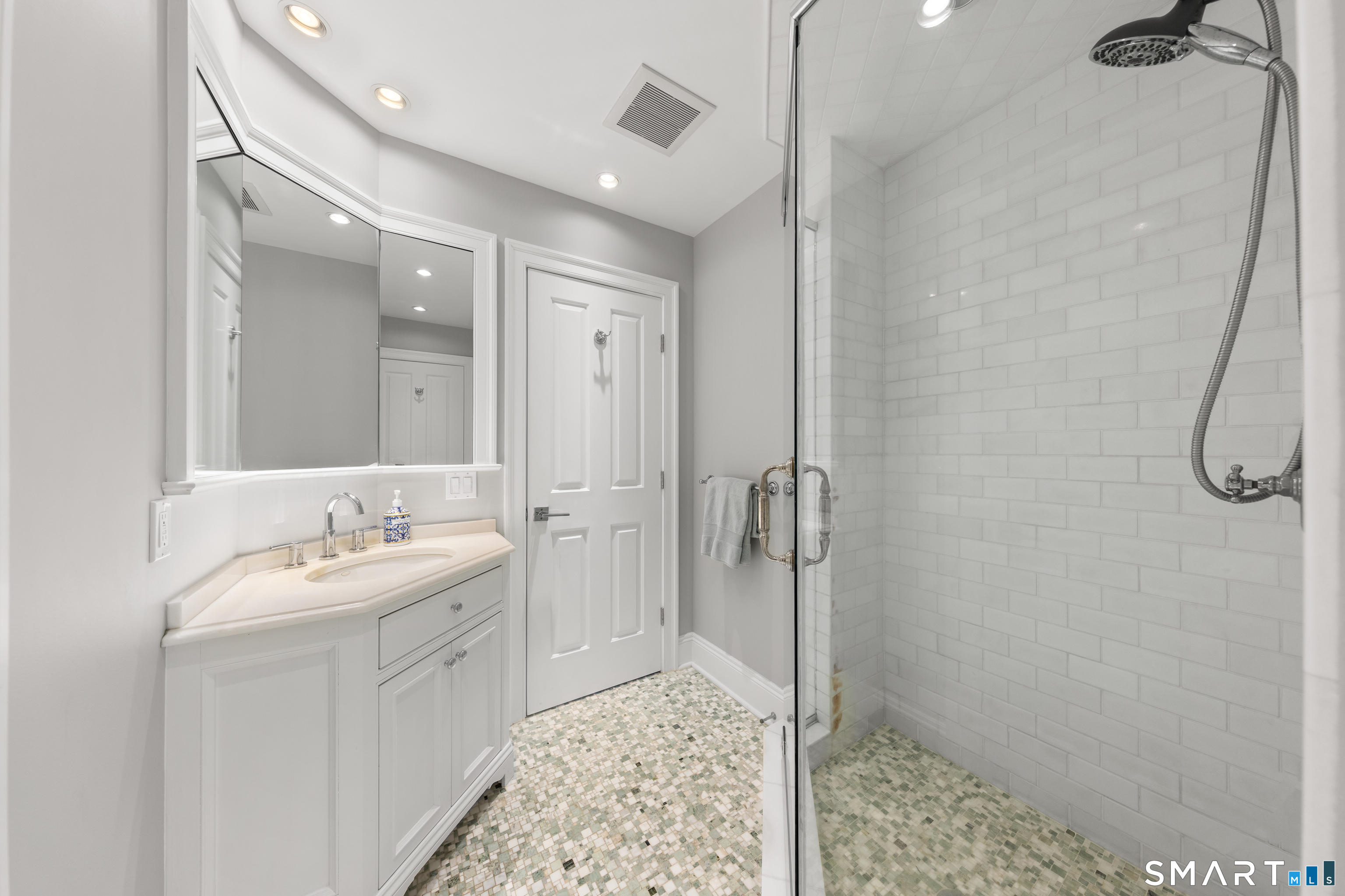 99 Hickok Road New Canaan, CT 06840 - Photo 22 of 39 a spacious bathroom with a shower sink and mirror