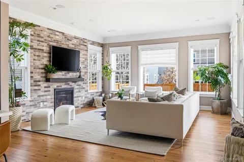 a living room with fireplace furniture and a flat screen tv