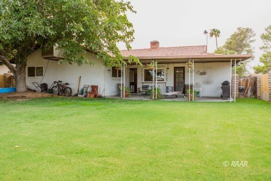 534 South Erin Street Ridgecrest, CA 93555 - Photo 27 of 29 a front view of a house with garden and trees