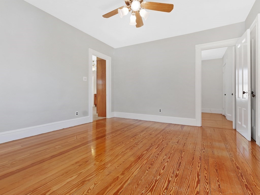 29 Garfield Avenue Boston, MA 02136 - Photo 12 of 27 wooden floor in an empty room with a window