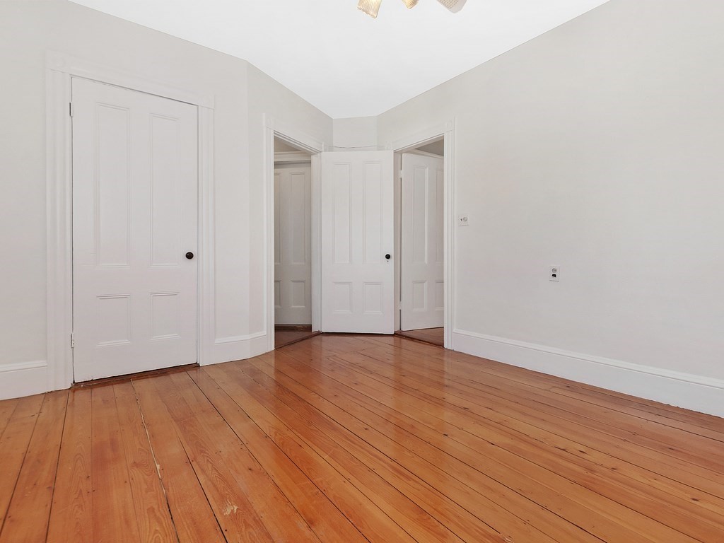 29 Garfield Avenue Boston, MA 02136 - Photo 13 of 27 a view of an empty room with wooden floor