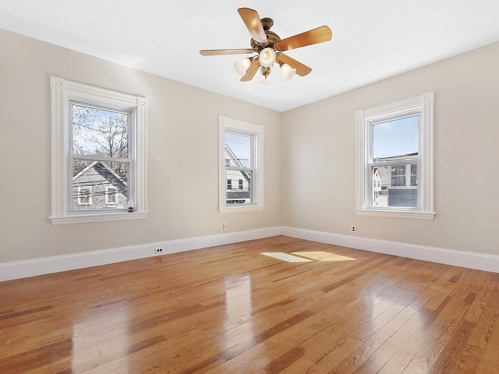 29 Garfield Avenue Boston, MA 02136 - Photo 15 of 27 a view of an empty room with window and wooden floor