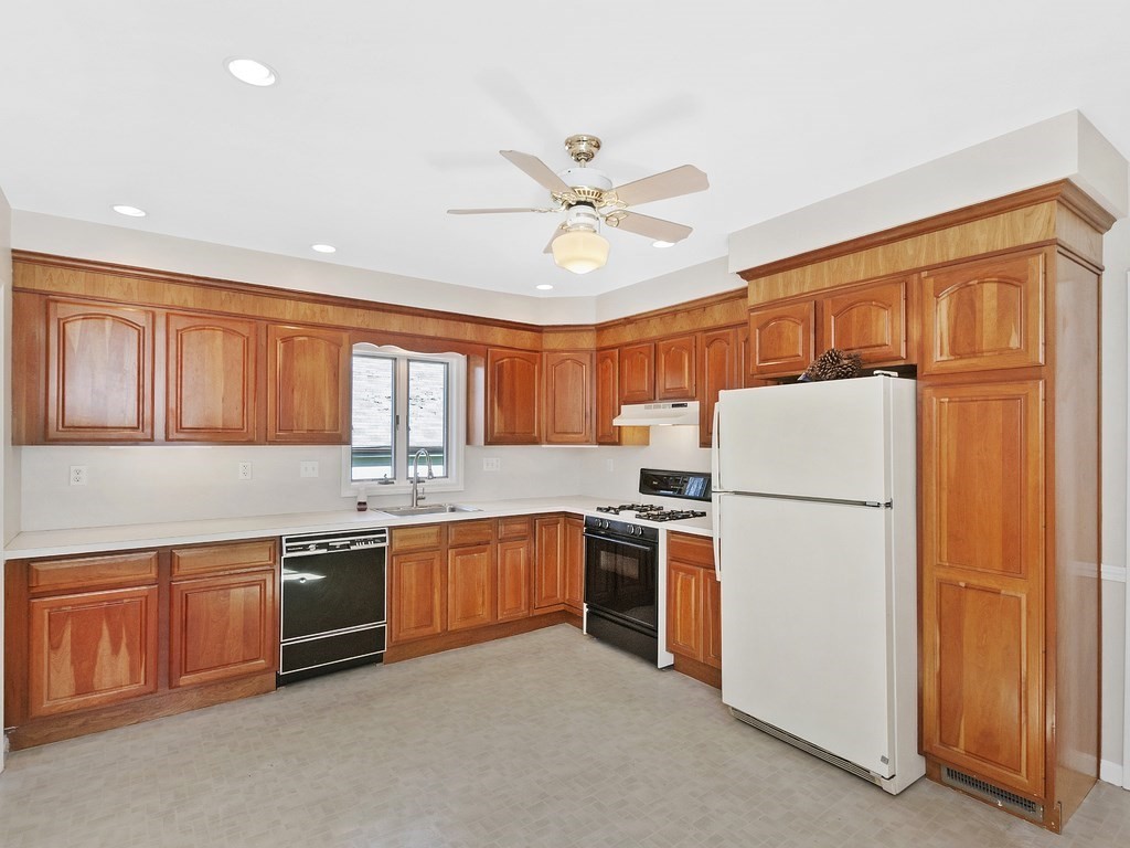 29 Garfield Avenue Boston, MA 02136 - Photo 2 of 27 a kitchen with stainless steel appliances granite countertop a refrigerator a stove a sink a with a dining table and chairs