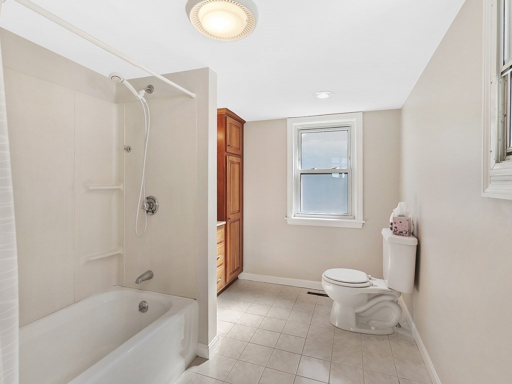29 Garfield Avenue Boston, MA 02136 - Photo 9 of 27 a bathroom with a toilet and a bathtub