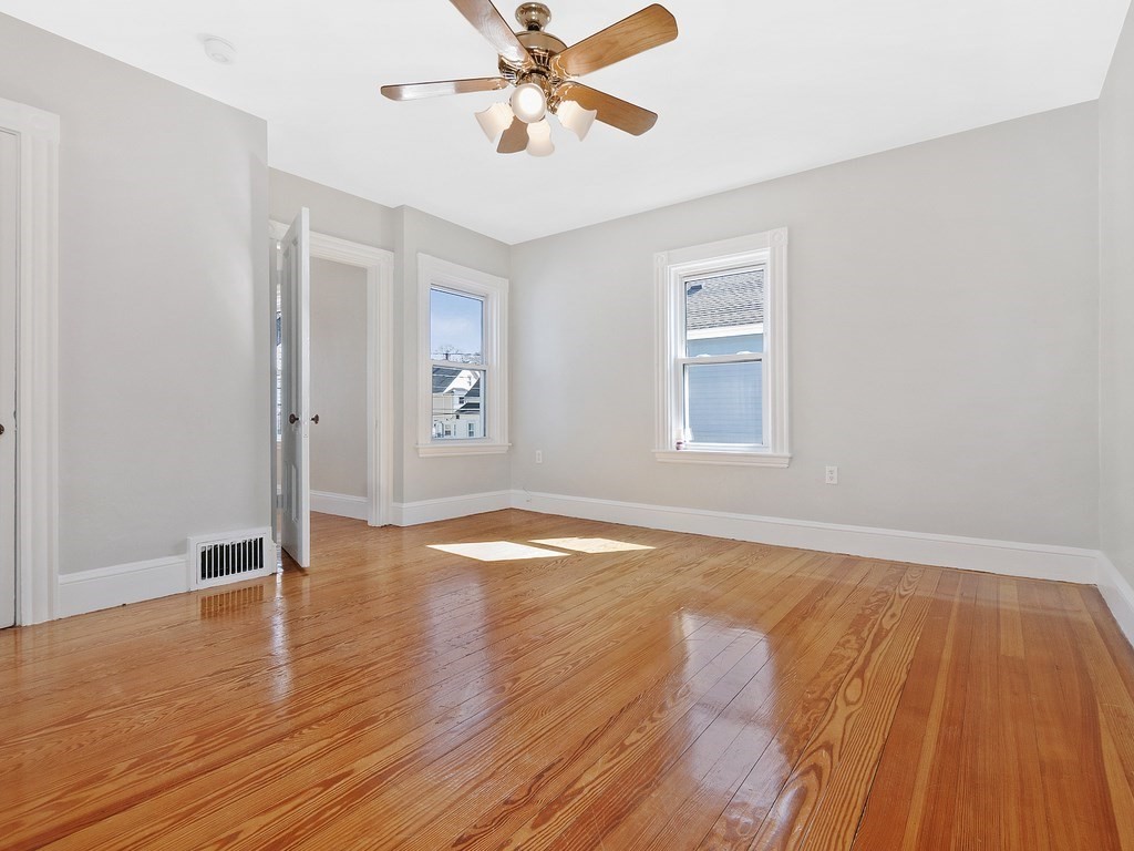 29 Garfield Avenue Boston, MA 02136 - Photo 10 of 27 a view of empty room with wooden floor and fan