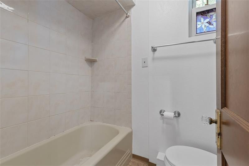 83 Gibson Street Pittsburgh, PA 15202 - Photo 13 of 27 a white bath tub sitting next to a toilet