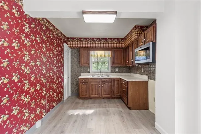 a spacious bathroom with a granite countertop sink and a large mirror
