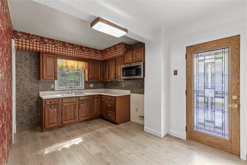 83 Gibson Street Pittsburgh, PA 15202 - Photo 17 of 27 a large kitchen with kitchen island granite countertop a sink window and stainless steel appliances