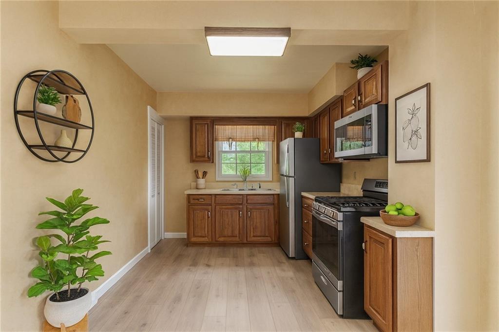 83 Gibson Street Pittsburgh, PA 15202 - Photo 18 of 27 a kitchen with stainless steel appliances a white stove top oven a sink a counter space and a window
