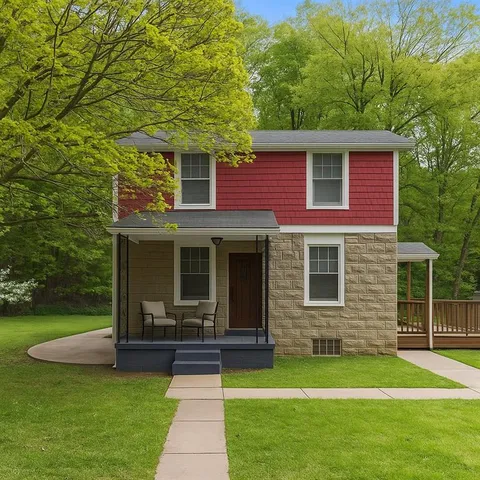 a view of a house with a yard porch and sitting area