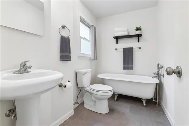 a bathroom with a sink toilet and a bathtub