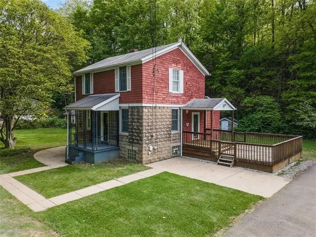 a front view of a house with a garden