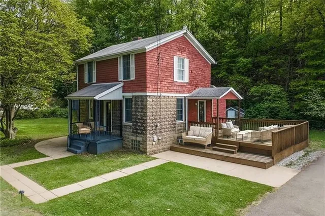 a front view of a house with a garden