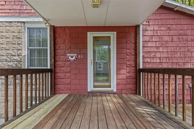 a view of a brick house with a wooden floor and a window